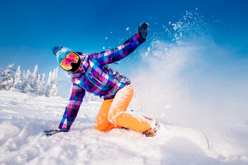 Snowboarder on snowboard rides through snow, explosion.
