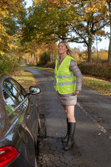 Woman driver wearing a reflective security jacket