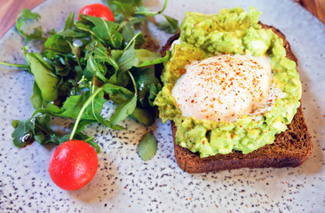 vegetable salad and a slice of bread with fried egg