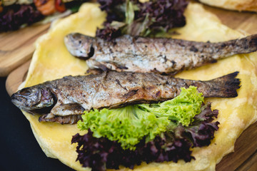 delicious food baked fish with salad