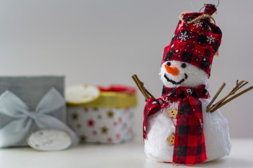 Snowman with gift boxes on the background
