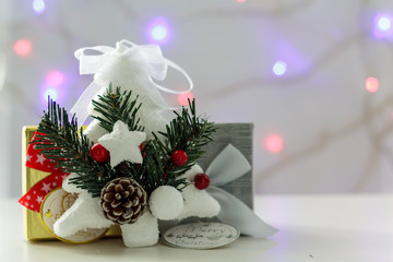 White christmas tree and christmas gift box with christmas lights on the background