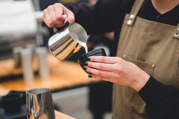 The barista brews a fragrant coffee