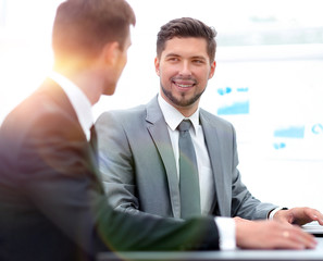 Manager with the colleague sitting at the Desk