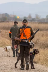 Rolgordijnen Hunter hunting with dogs in nature © predrag1