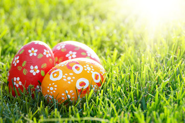Handmade Painted Easter eggs on green spring grass. Space for text