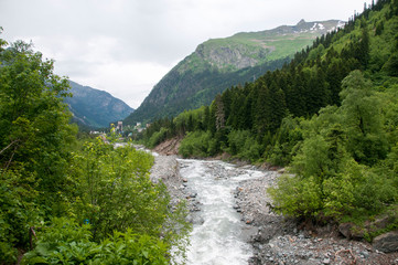 Fototapeta na wymiar Closeup view mountains and river scenes in national park Dombai, Caucasus, Russia, Europe.