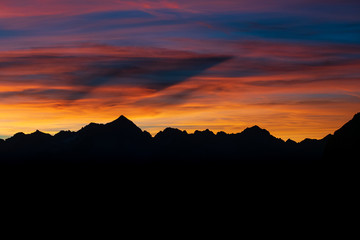 Dark Silhouette of Mountains and sunset. Mountain peaks Dolomites. Brenta, Italy