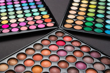 Make-up eyshadow palettes on a black background