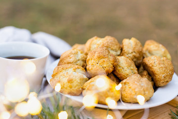 Close-up of a coffee cup, sweet cookies on a table outdoor
