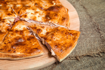 stuffed closed Calzone Pizza on a natural background