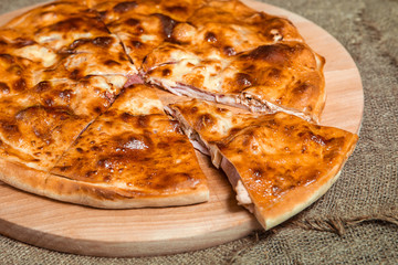 stuffed closed Calzone Pizza on a natural background