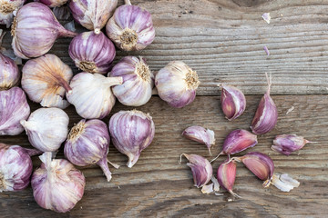 Garlic cloves on wooden vintage background. Seedlings for planting garlic.