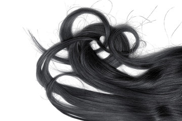 A strands of long, twisted, black hair isolated on white background