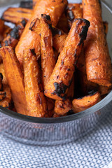 Close up on a glass bowl of roasted carrots