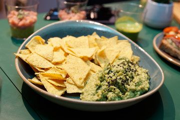 Guacamole dip sauce and nachos chips