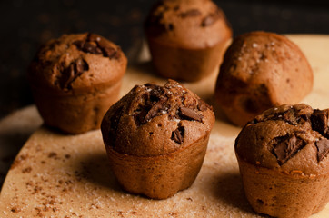 Chocolate cupcakes with chocolate chips on a dark background