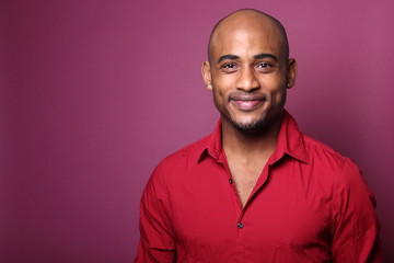 Black man in front of a colored background