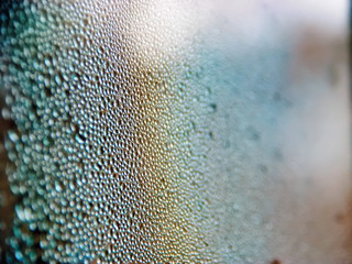 Drops of water on a cold glass.
