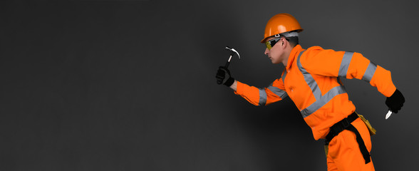 A running builder worker with hammer and pliers. Hurry up repair concept.