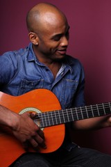 Black man in front of a colored background