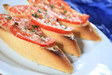Sandwiches with tomatoes and melted cheese on top