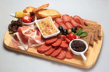 A mix of salami, cheese, ham on a plateau