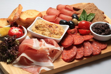 A mix of salami, cheese, ham on a plateau