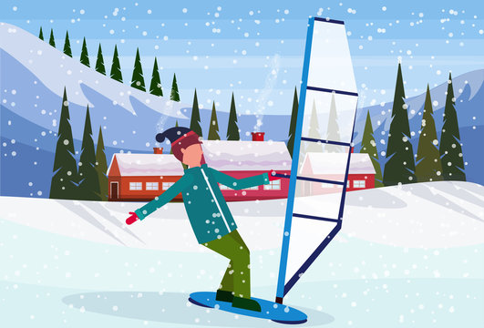 man windboarding windsurfing on snow over small village houses winter snowy mountains hills fir tree forest landscape background horizontal flat