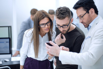 close up.group employee looking at the smartphone screen