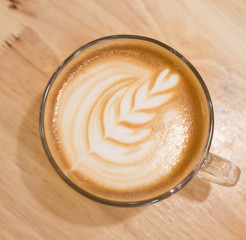 Cup of Art Cappuccino coffee on the wood table