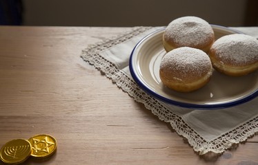 Hanukkah celebration concept-closeup of donuts and chocolate coi
