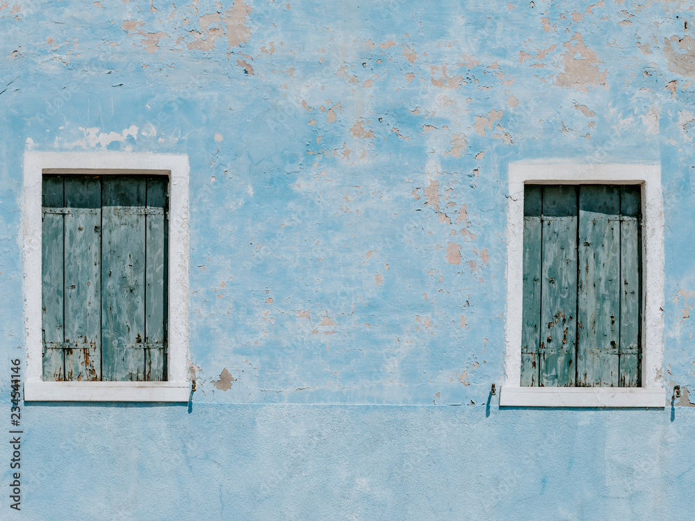 Wall mural old blue house wall with two wooden windows