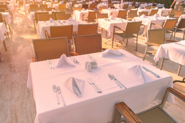 Chairs and tables at sunset at hotel restaurant