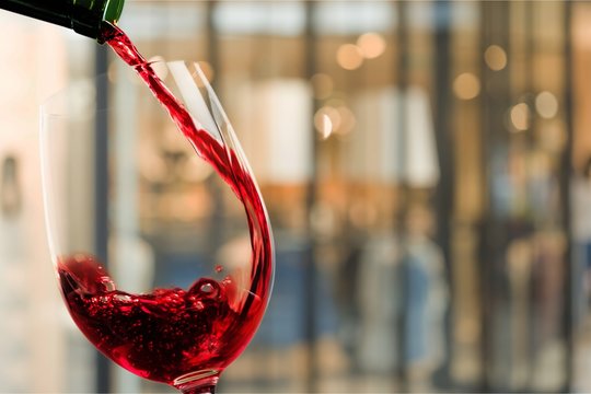 Red wine glass on background