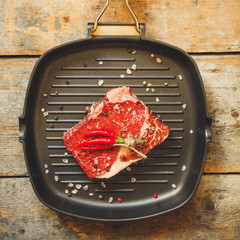 beef steak raw (Grilled meats with spices) - a piece of meat. Top view with copy space