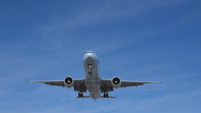 Slow motion. Commercial jet coming into land . Boeing 777-233 (LR) landing at YYZ in Toronto. No visible logos. Room for copy.