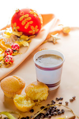 Christmas decor and a glass of coffee on a light textile background with space for text