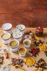 various coffee drinks and Christmas decor on a light textile background with space for text