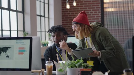 young business people working in startup office caucasian team leader woman pointing at tablet computer screen showing colleague creative ideas training intern brainstorming discussing information
