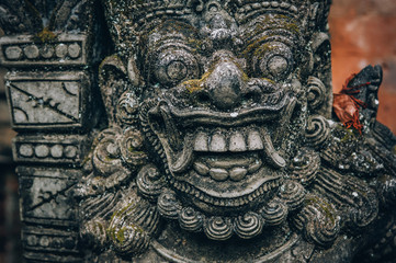 Closeup portrait of Hindu Buddhist traditional stone sculpture. Bali, Indonesia
