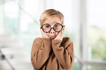 Portrait of a cute young boy with glasses isolated on
