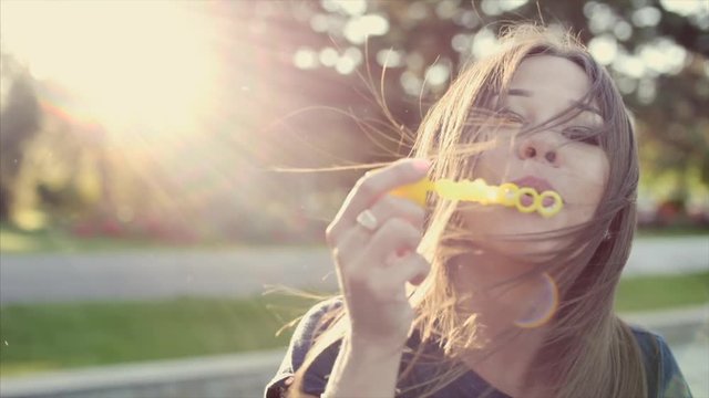 Your woman blows bubbles.