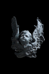 sculpture of an angel with dark background