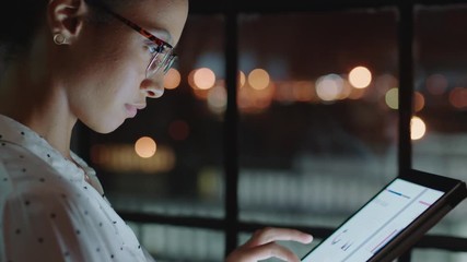 close up beautiful business woman working late using tablet computer browsing research data statistics on screen brainstorming successful project deadline strategy looking out window planning ahead - Powered by Adobe