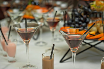 Glass glasses with colored drinks on the table. alcoholic drinks at the buffet