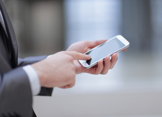 close up.the businessman clicks on the smartphone screen