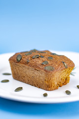 Gluten-Free pumpkin bread with pumpkin seed in white plate.