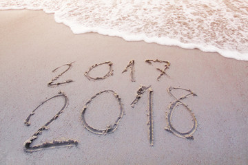 New Year 2018 is coming concept. Happy New Year 2018 replace 2017 concept on the sea beach .at phuket Thailand