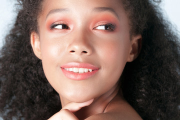 Young beautiful black girl with clean perfect skin close-up